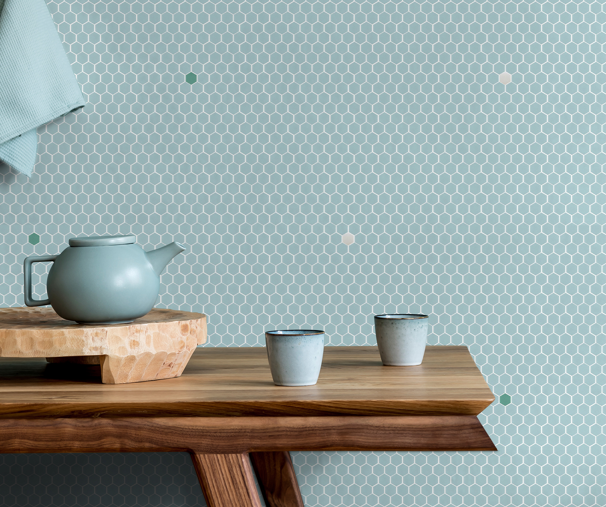 Stylish and minimalistic dining room interior with wooden table, teapot with cups, fruit tray and elegant accessories. Eucalyptus color. Ready to use. Template. Modern home decor. Copy space.