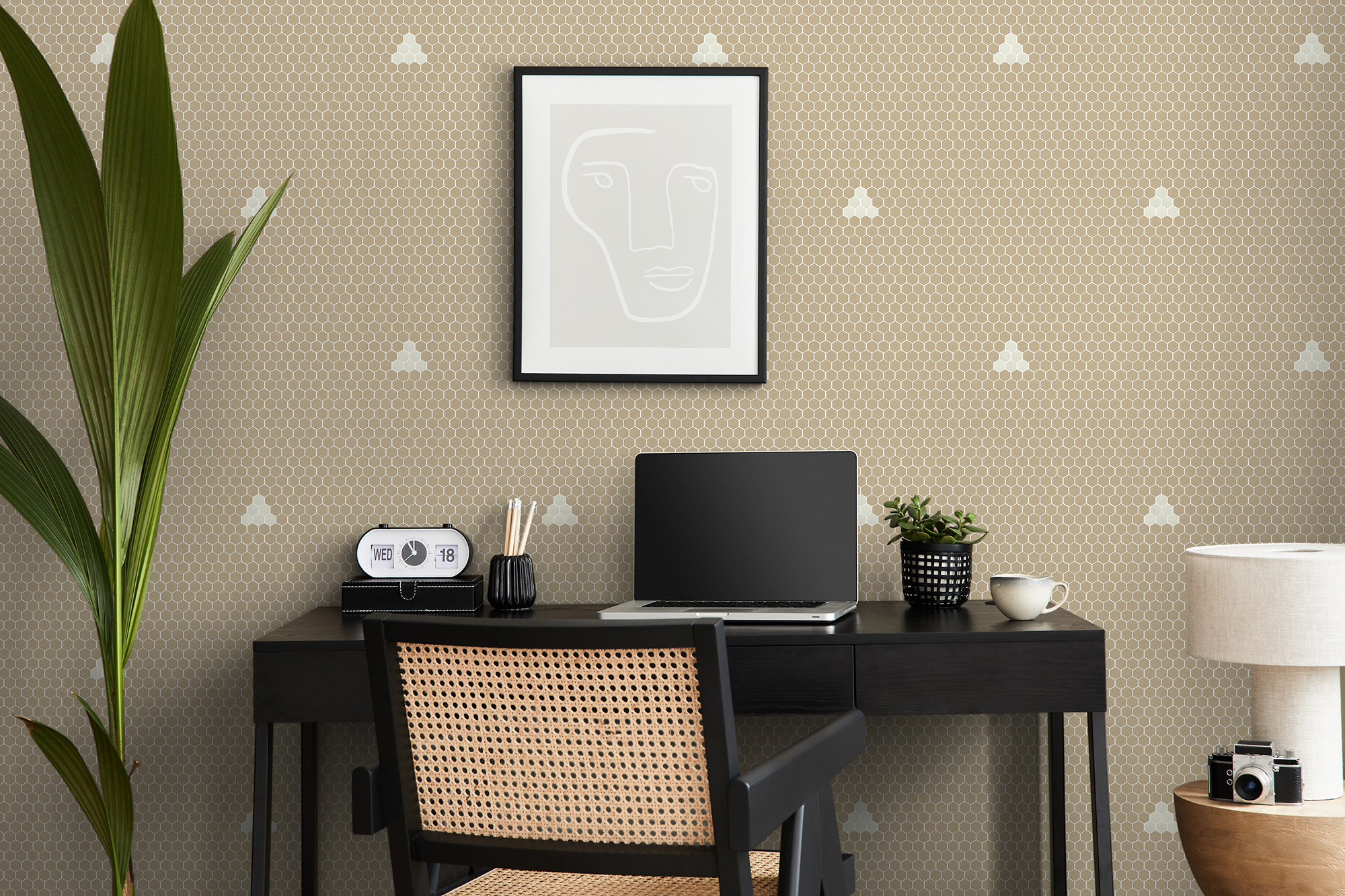Modern interior design of home office space with stylish chair, desk, commode, black mock up poster frame, lapatop, book, office supply and elegant presonal accessories in home decor. Template.
