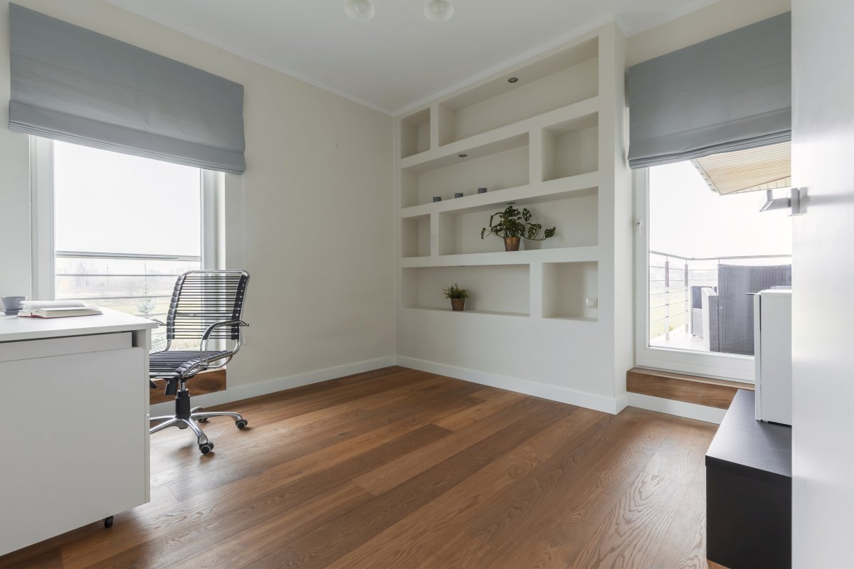 Spacious modern designed office with white furniture and wooden floor